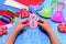 Child holds a felt snowman ornament in his hands. Christmas sewing crafts concept. Christmas tree, heart, star, snowman crafts