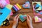Child holds a felt valentine in his hands. Child made valentines from felt. Valentines day crafts idea. Felt heart ornaments