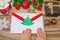 A child holds a letter to Santa Claus at the North Pole in Lapland, children`s hands on a wooden background with decorations and C