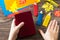 Child holds multi-colored bookmarks origami pencil made of paper new school year on a wooden table.