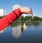 The child holds in the palm of a carp, which was caught in the pond of the city Park. City Park on a Sunny autumn day. hobby fishi