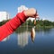 The child holds in the palm of a carp, which was caught in the pond of the city Park. City Park on a Sunny autumn day. hobby fishi