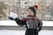 Child holds piece of snow in his hands. Boy playing snowballs