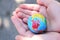 The child holds the planet Earth in his hands. Earth day. The green concept. A toy globe in children`s hands