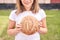 Child holds round bread. Healthy food. Carrying big fresh baker bun