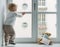 Child in home quarantine playing at the window with his sick teddy bear wearing a medical mask against viruses during coronavirus