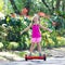 Child on hover board. Kids ride scooter.