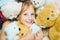 Child hugging teddy bear. Kid funny face near toys. Toys dream. Kid girl dreams near tiys teddy. Childhood dream