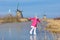 Child ice skating on frozen mill canal in Holland