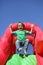 Child on inflatable bouncy castle slide