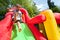 Child on inflatable bouncy castle slide