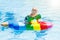 Child on inflatable float in swimming pool.