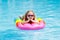 Child on inflatable float in swimming pool.