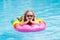 Child on inflatable float in swimming pool.