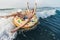 Child on inflatable ring ride on breaking wave. Travel lifestyle, swimming activities. Selective focus