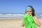 Child inflating inflatable swim ring on the beach