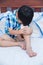 Child injured. Wound on the child\'s knee with bandage.