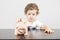 Child inserting coins in a piggy bank