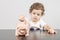 Child inserting coins in a piggy bank