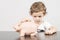 Child inserting coins in a piggy bank