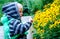 Child inspects garden flowers