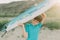 A child jokingly rides on an ironing board instead of a surfboard