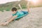 A child jokingly rides on an ironing board instead of a surfboard