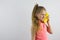 The child jokingly speaks on the banana phone and laughs