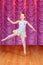 Child jumping ballerina dancer on stage