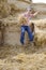 Child jumping in haystack