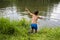 Child jumping into lake or pond