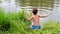 Child jumping into lake or pond