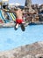 child jumps with a run in the pool