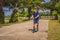 Child on kick scooter in park. Kids learn to skate roller board. Little boy skating on sunny summer day. Outdoor