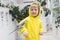 Child kid boy in bright yellow hooded sweatshirt, modern casual laughs sitting on his hand gray huge big domestic