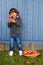 Child kid eating apple fruit full body outdoor copyspace autumn