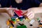 Child, kid plays with colored plastic parts of the constructor, creates buildings, equipment, transport, the concept of the