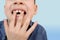 Child, kid shows with his finger a milk tooth that sways and hurts, the concept of pediatric dentistry, dental treatment and