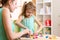 Child kid and woman play colorful clay toy at