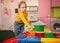 child in kindergarten, playroom, playing with toys, learning. Plays with