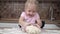 child kneads the dough on the kitchen table. A 4-5 year old girl learns to cook