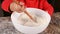 Child kneads flour with a spoon