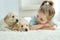 Child with labrador puppies at home on the carpet.