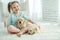 Child with labrador puppies at home on the carpet.