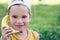 Child laughing while playing pretend with a wooden banana phone