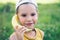 Child laughing while playing pretend with a wooden banana phone