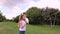 The child launches a paper plane. girl in a green park