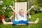 Child laying relaxed in deck chair in summer