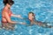 Child learn swim in swimming pool.