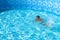 Child learn to swim, dive in blue pool with fun - jumping deep down underwater with splashes